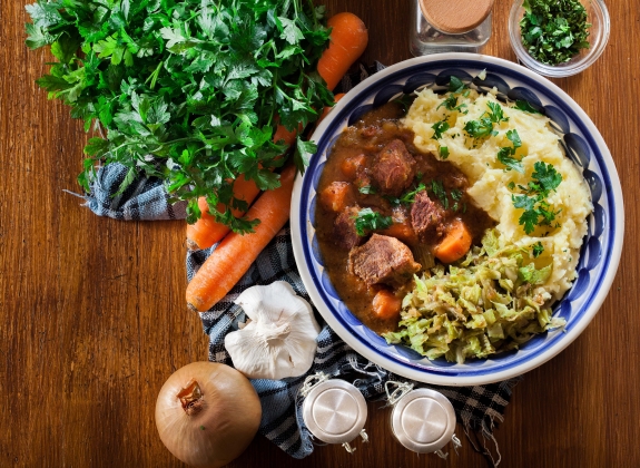 Traditional irish stew served with mashed potatoes and cabbage. Top view