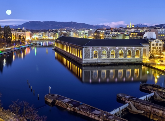 cathedral Saint-Pierre green tower and Rhone river by night with full moon, Geneva, Switzerland