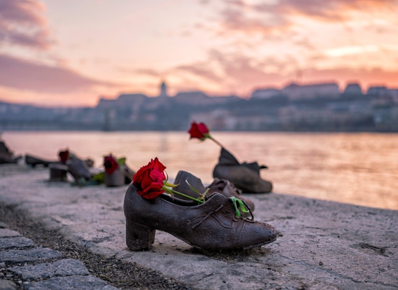 "Shoes on the Danube bank" - Monument as a memorial of the victims of the Holocaust during WWII on the bank of the Danube at sunset in Budapest, Hungary