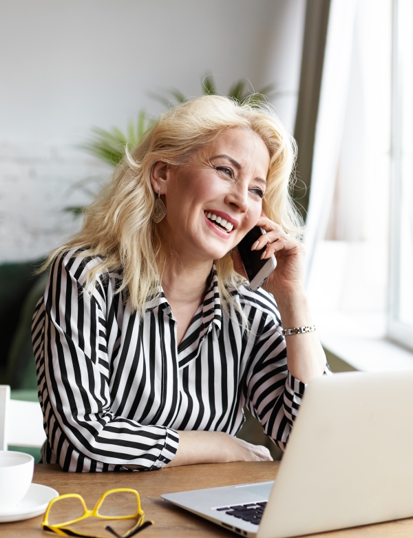 woman sitting at desk in front of open laptop