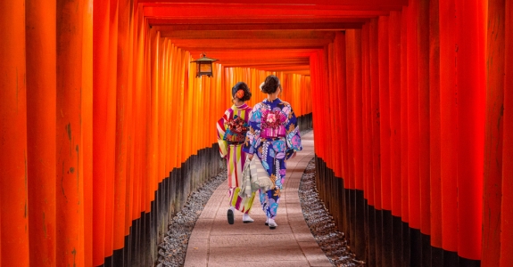 Women in traditional japanese kimonos walking at Fushimi Inari Shrine in Kyoto, Japan