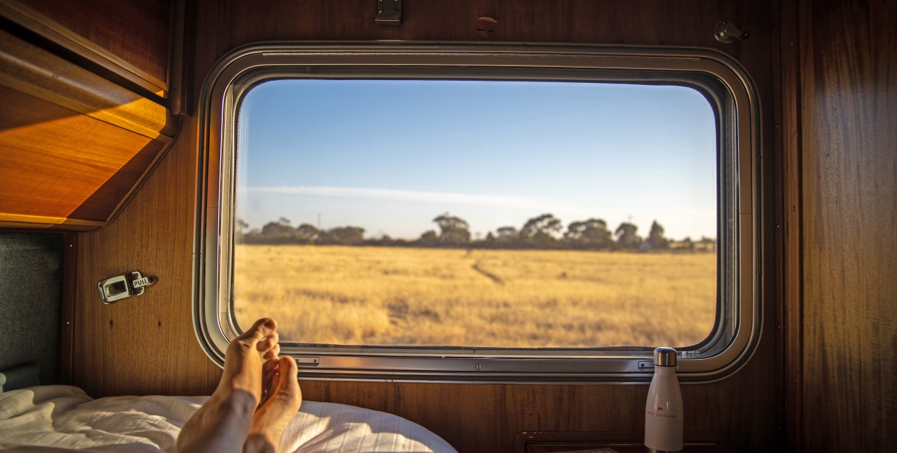Person laying down in the Gold Class Single accommodation