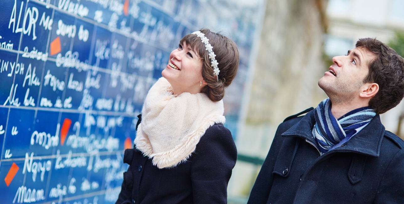 Romantic couple near I love you wall in Paris