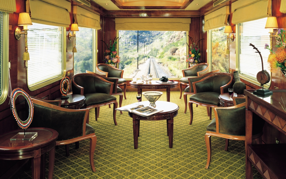 The Blue Train Observation Car Inside a luxurious train carriage, lounge chairs and coffee tables