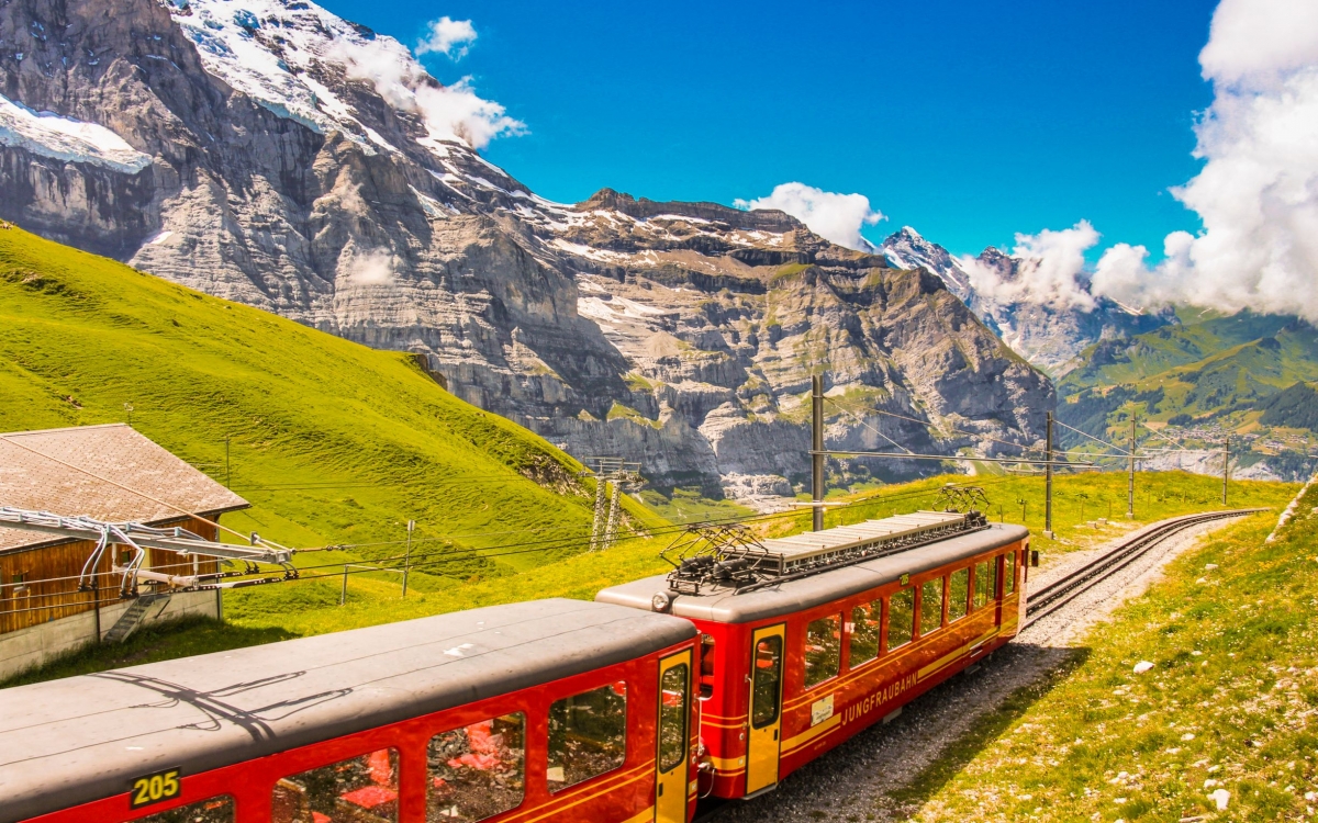 The Jungfrau Railway A train travels through Alpine landscape up a mountain