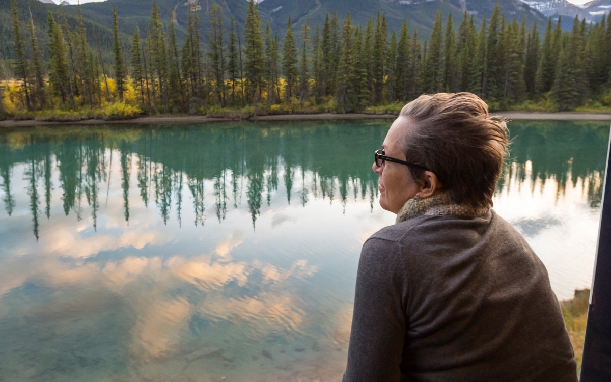 Man on Rocky Mountaineer's outdoor viewing platform