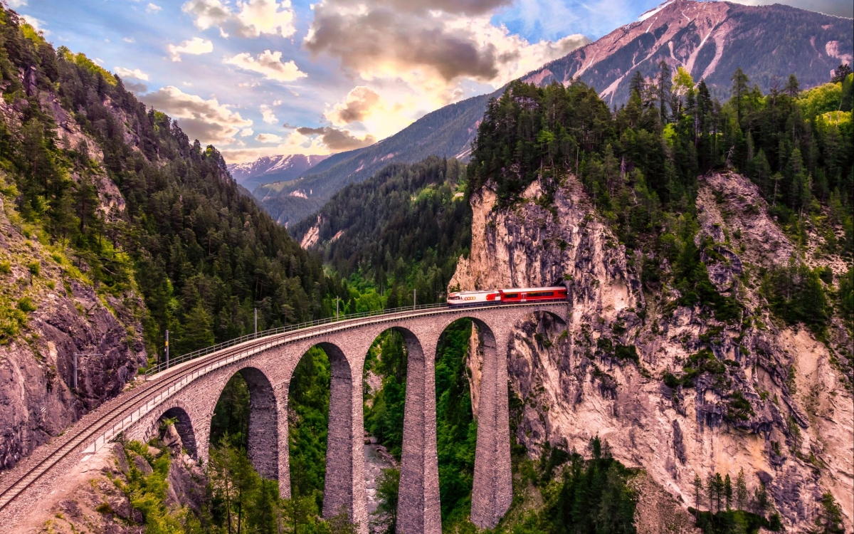 The Landwasser Viadauct - the Bernina Express A train emerges from a tunnel crossing a viaduct