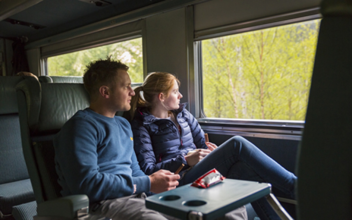 couple looking out window on via rail Economy class