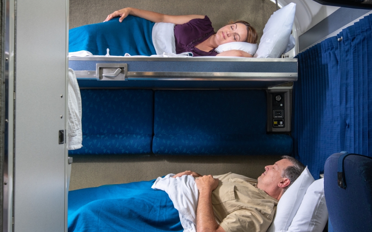 couple laying in Amtrak's bedroom suite bunk beds at night