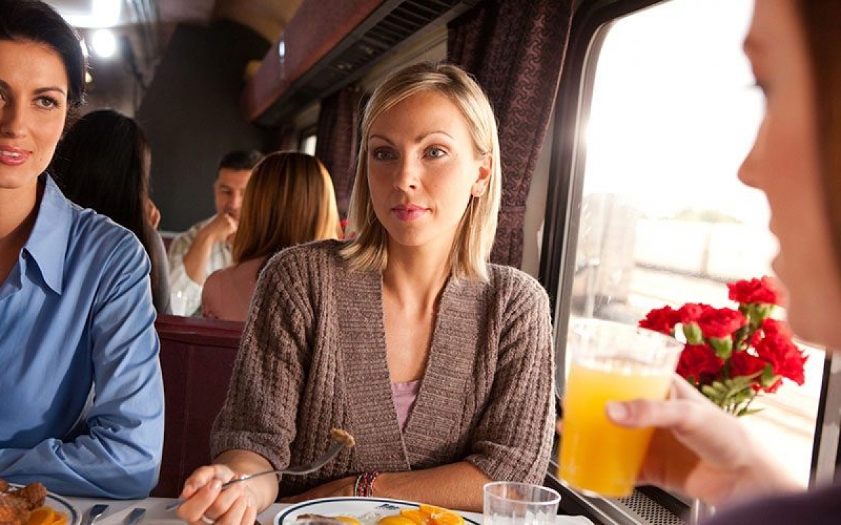 woman at a dining room table onboard Amtrak trains