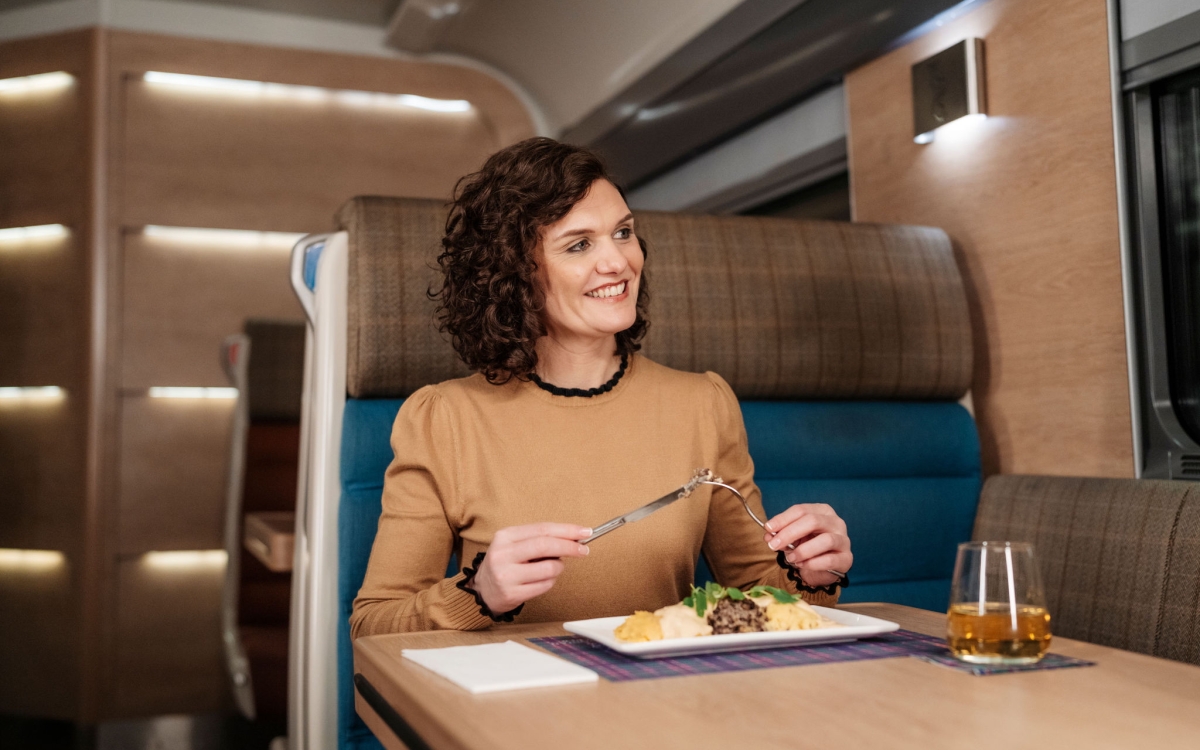 woman dining on the Caledonian Sleeper