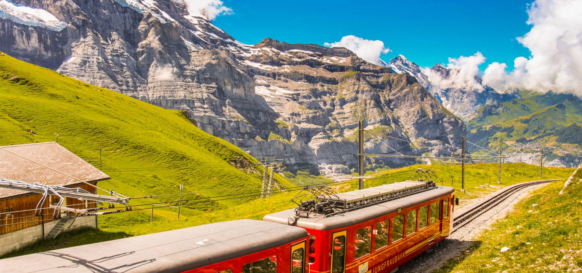 A train travels through Alpine landscape up a mountain