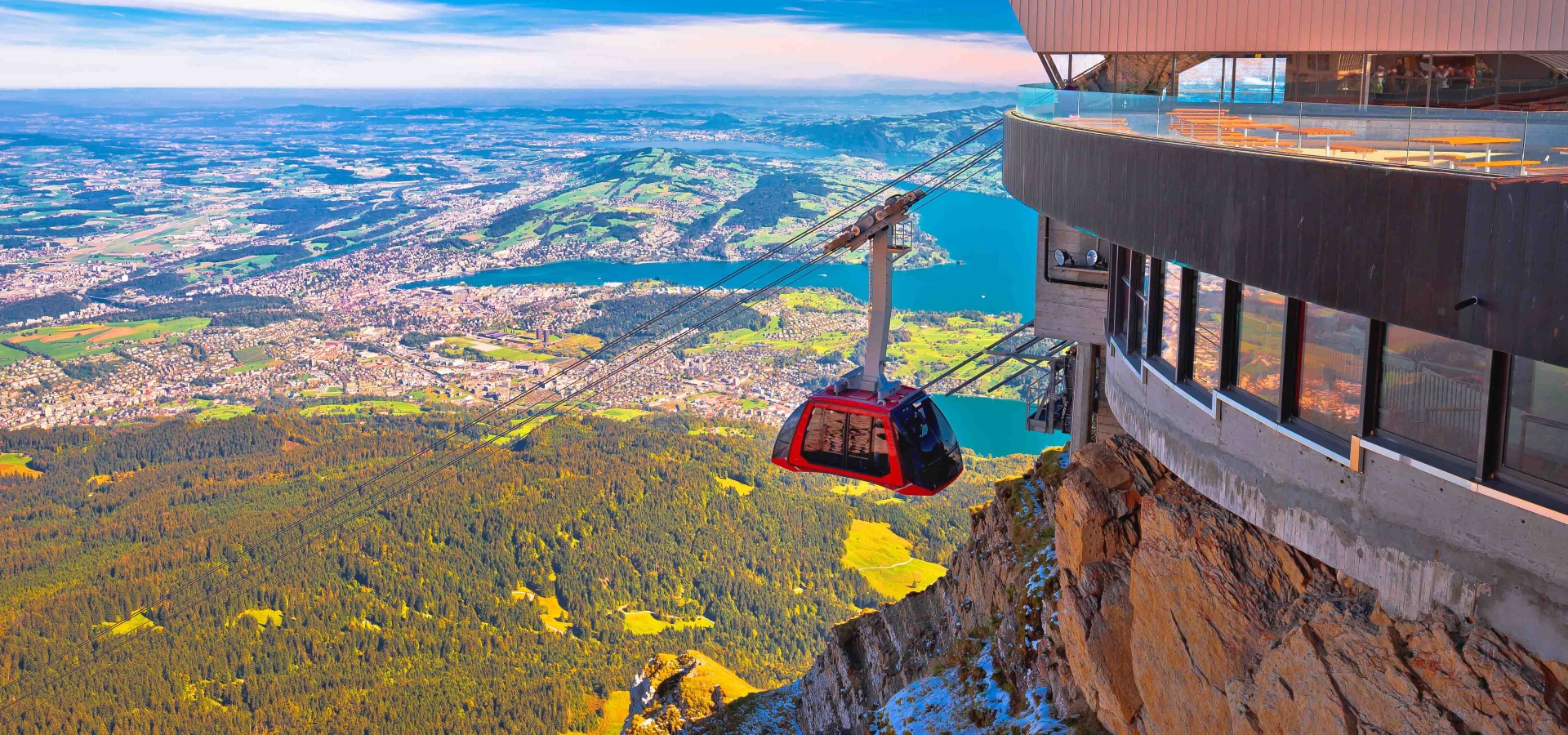 A Gondola approaches the terminal with mountain views in background