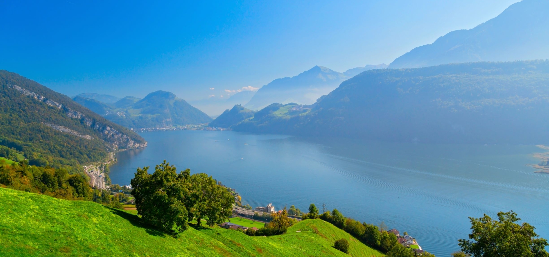 View down from the mountain side over a bright blue lake