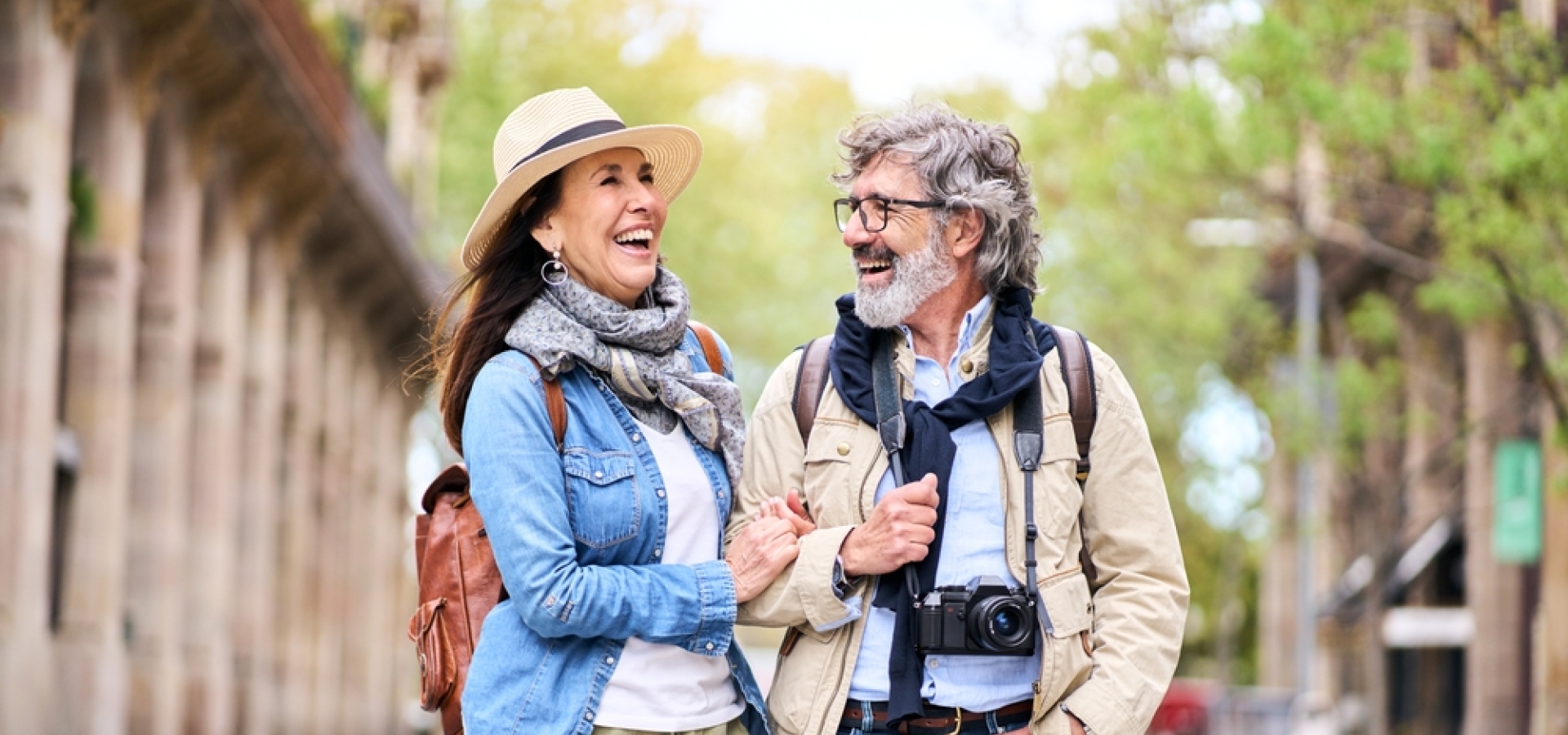 Happy older couple having fun walking outdoors in city.