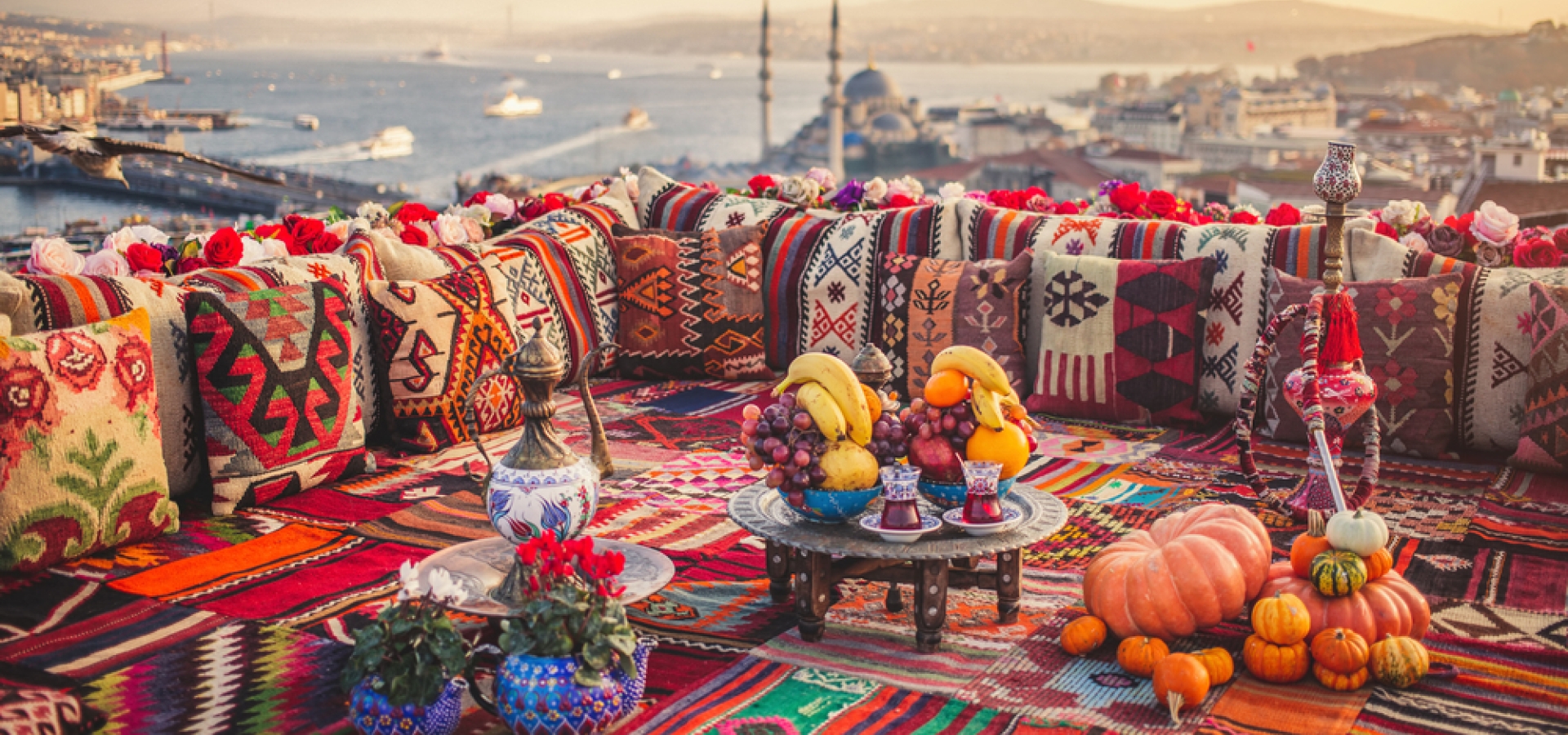 Great panoramic view of Istanbul from high terrace decorated traditional colorful ornamental pillows and carpets. Selective focus