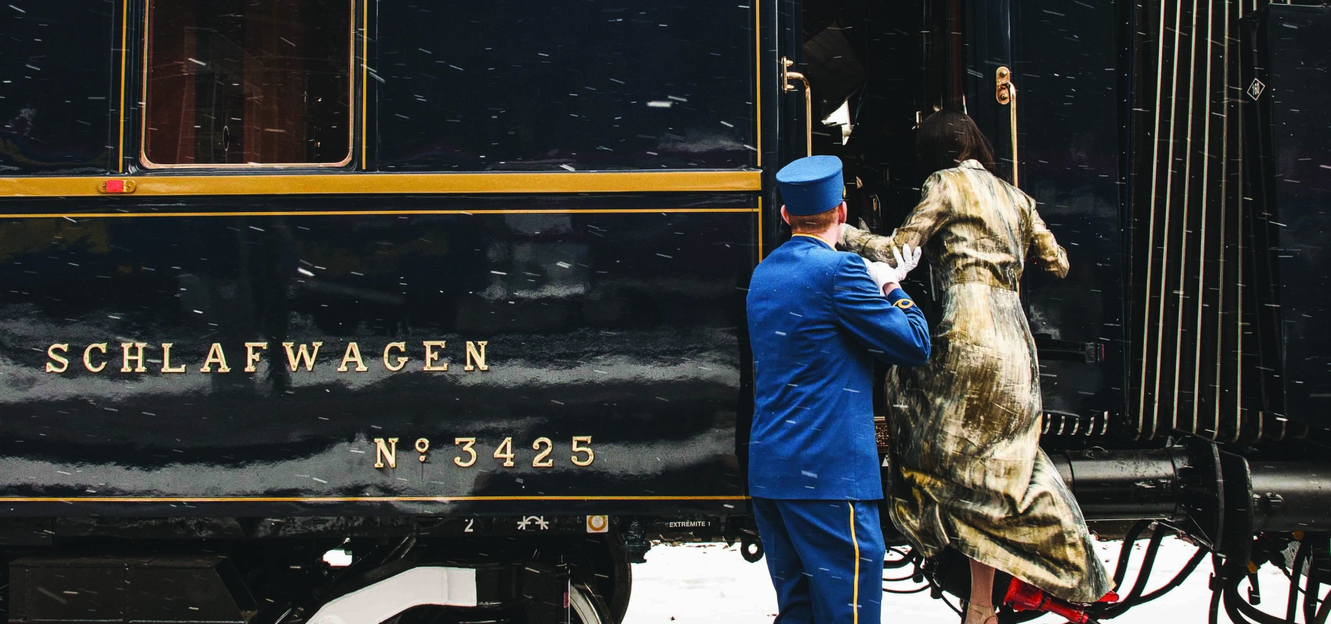 venice-simplon-orient-express man helping woman on to train