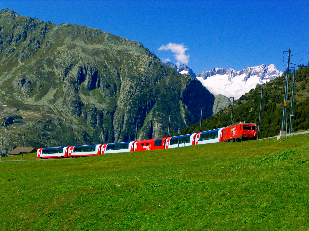 The Glacier Express A train travels through lush swiss countryside
