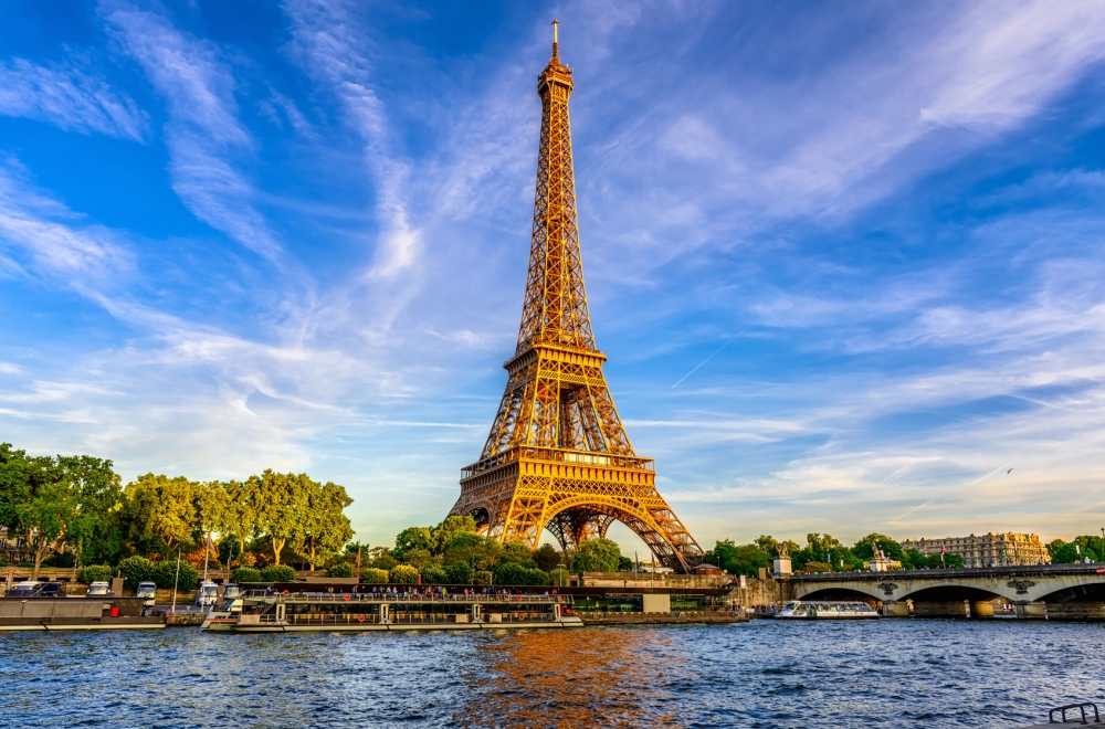 Paris Eiffel Tower and river Seine at sunset in Paris, France. Eiffel Tower is one of the most iconic landmarks of Paris.