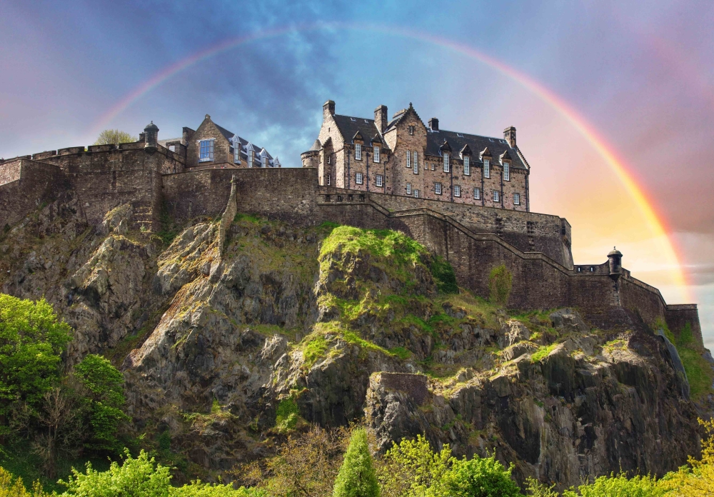 Scotland - Rainbow over Edinburgh Castle with green garden, UK