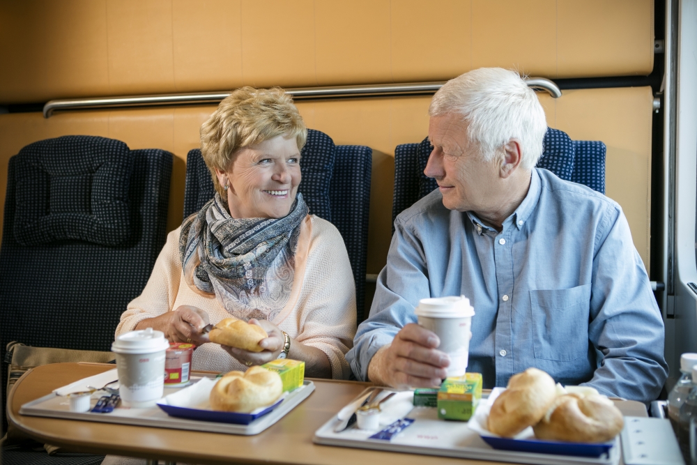 happy couple dining on nightJet sleeper train in Europe