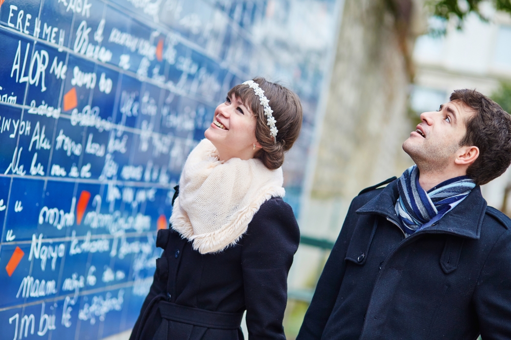 Romantic couple near I love you wall in Paris