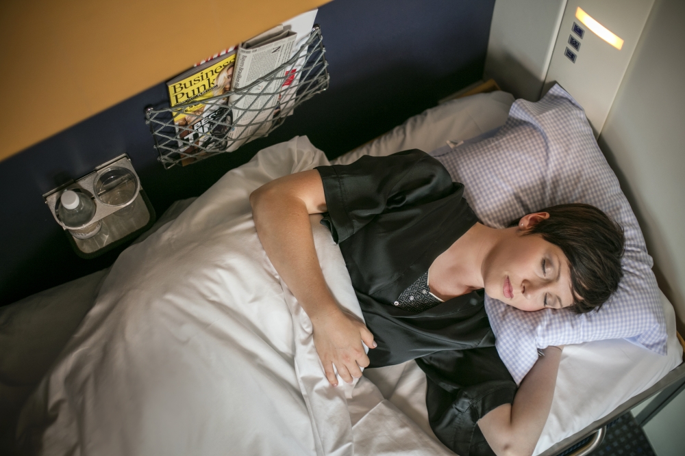 woman sleeping in NightJet train in Europe
